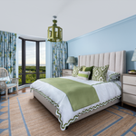 Colourful bedroom with scallop jute rug Matouk bedding and blue and green lantern with Thibaut drapery Florida coastal living